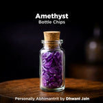 Glass bottle filled with purple amethyst chips on a wooden surface with a dark background.