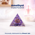 Amethyst crystal pyramid with a spiral design on a white surface, featuring the brand 'Dhwani Jain'.