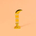 Gold curved object on a peach background