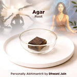 Brown agar root in a glass bowl with a blurred background featuring people and plants.