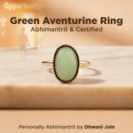 Green aventurine ring with gold band on a beige surface, text about opportunity and certification.