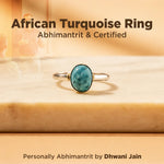 African Turquoise Ring on a wooden surface with text about certification and creator.