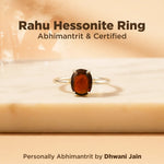 Rahu Hessonite Ring on a beige background with text about certification and abhimantrit.