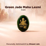 Green jade Maha Laxmi coin with gold embossed design on a beige background
