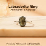 Labradorite ring on a wooden surface with text about certification and branding.