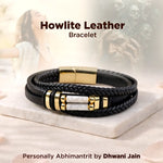 Black leather bracelet with gold accents on a marble surface, labeled 'Howlite Leather Bracelet' by Dhwani Jain.