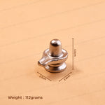 A small metallic silver object, likely a decorative or functional hardware piece, shown on a beige background with dimensions