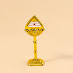 Gold-colored decorative item on a beige background