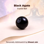 Black agate crystal ball on a soft background with text indicating brand and creator.