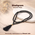 Shaligram Crystal Mala necklace with tassel on a beige background, featuring the brand 'Dhwani Jain'.