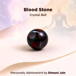 Blood stone crystal ball with a blurred figure in the background