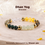 Beaded bracelet with gold, green, and clear beads on a light background, labeled 'Dhan Yog Bracelet'.