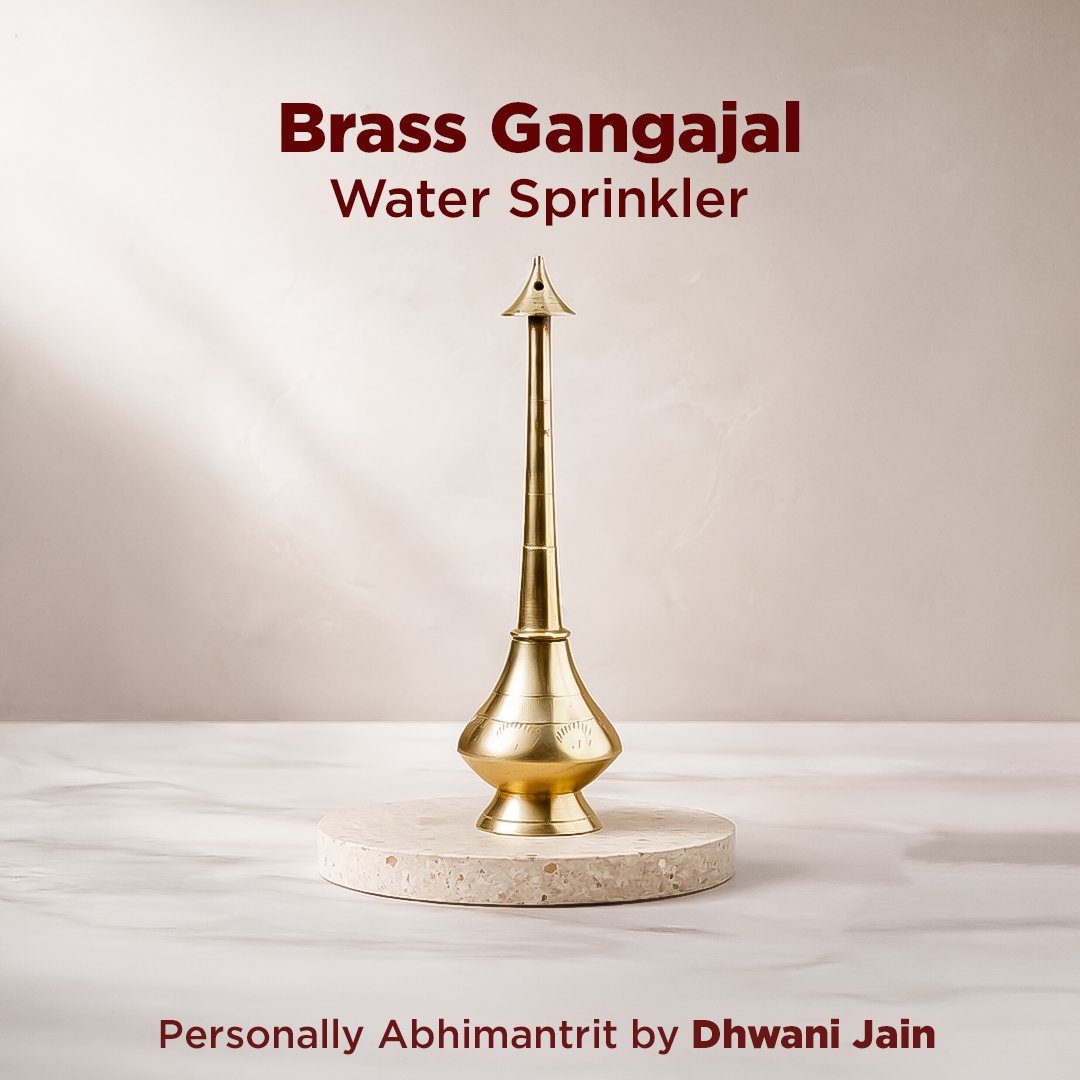 Brass Gangajal water sprinkler on a marble base with a plain background
