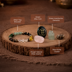 Collection of crystals and a bracelet on a wooden surface with labels.