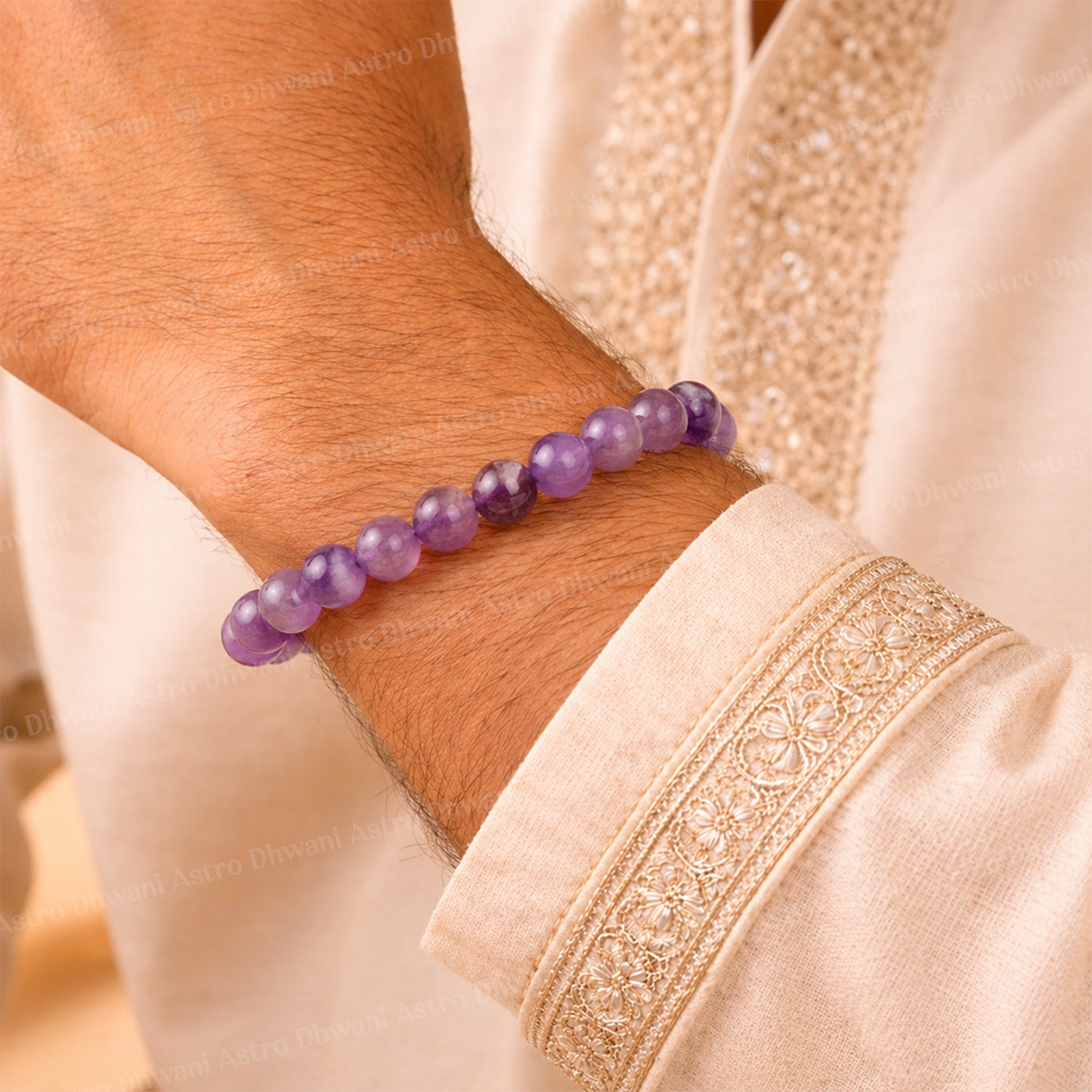 Purple beaded bracelet on a wrist with a beige garment backgroundप्राकृतिक आकर्षण प्यार, भाग्य, सद्भाव और अच्छा स्वास्थ्य कंगन (नीलम) - अभिमंत्रित और प्रमाणित