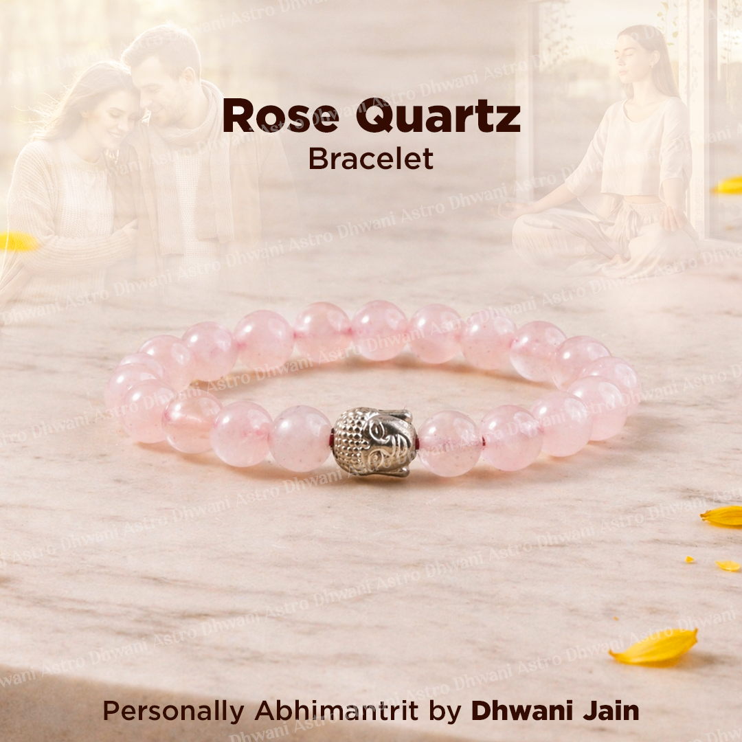 Rose Quartz bracelet with a silver owl charm on a light wooden background.