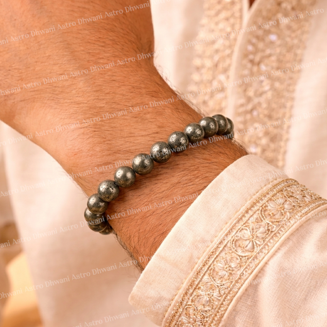 Beaded bracelet on a wrist with a light pink garment in the backgroundRaw Pyrite Bracelet for Attracts Wealth and Abundance