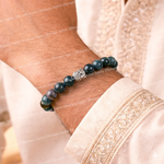 Beaded bracelet on a wrist with a light-colored garment