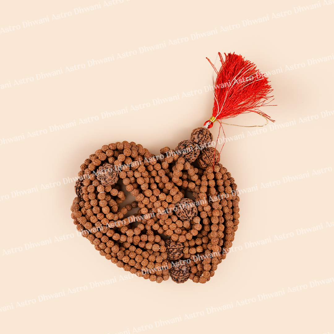 Brown beaded mala with a red tassel on a beige background