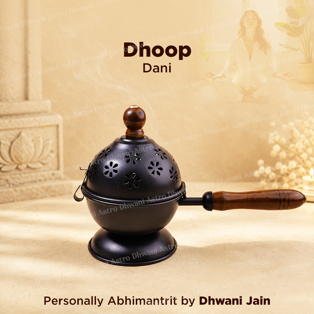 A black metal Dhoop Dani incense burner with a wooden handle and top knob, shown on a beige background with decorative text reading 'Dhoop Dani' and 'Personally Abhimanit by Dhwani Jain'.