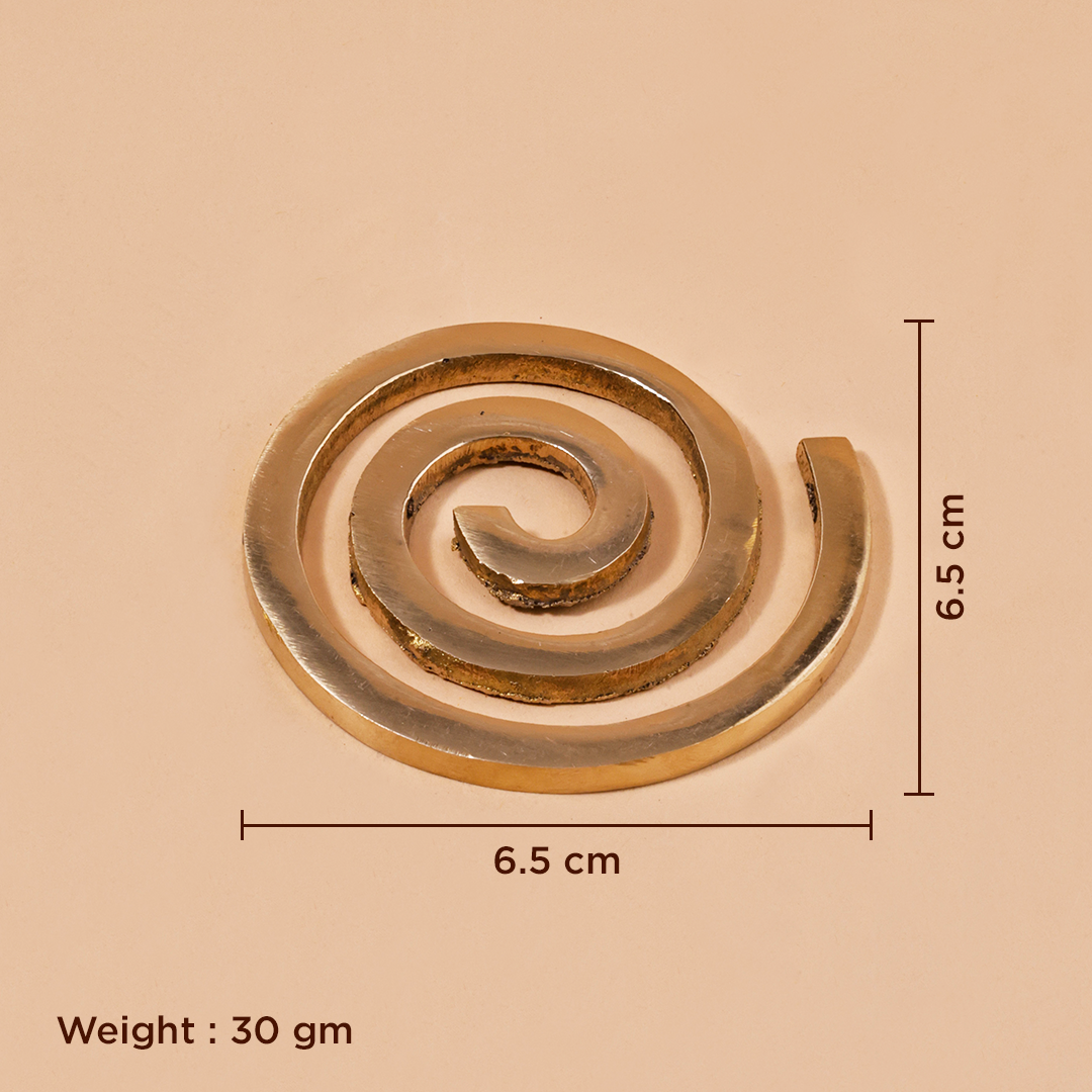 A spiral-shaped metallic gold object on a beige background.