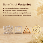 Benefits of Vastu Set text on a warm beige background with four metallic decorative symbols aligned at the bottom: a silver kantha-style motif, a silver square with a white center, a gold triangle with a white center, and a gold spiral. Decorative stacked money and flowers appear in the corners.