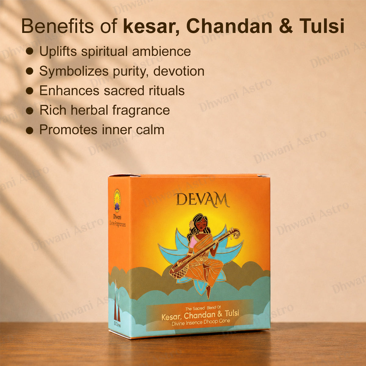 A boxed product labeled DEVAM Kesar, Chandan & Tulsi sits on a wooden surface against a warm beige wall. Text at the top lists benefits in Hindi/English, and the box shows an illustrated woman playing a stringed instrument with orange, yellow, blue, and cream tones.