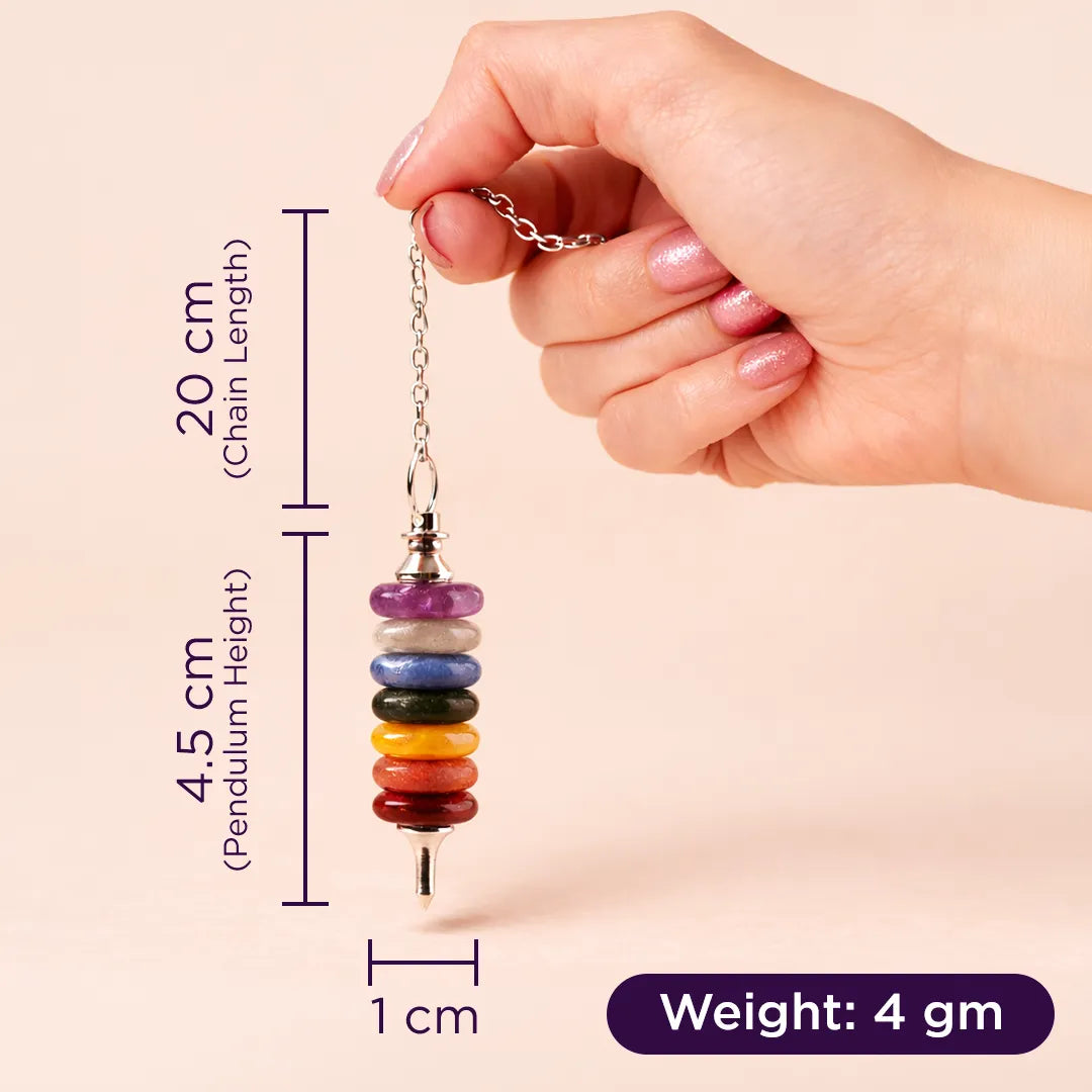 Hand holding a colorful beaded pendant with measurements on a beige background