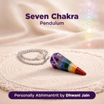 Seven Chakra Pendulum on a textured surface with a soft focus background