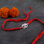Luxury 925 Sterling Silver Mahadev Rakhi bracelet with Shiva-inspired charm and adjustable handmade red thread.