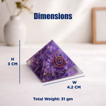 Purple crystal pyramid with measurements on a white surface