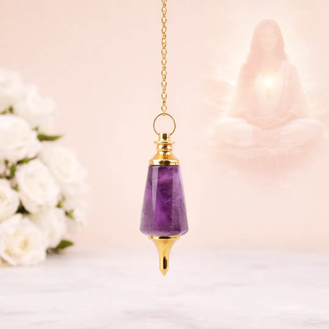 Amethyst pendulum with gold top on a blurred background