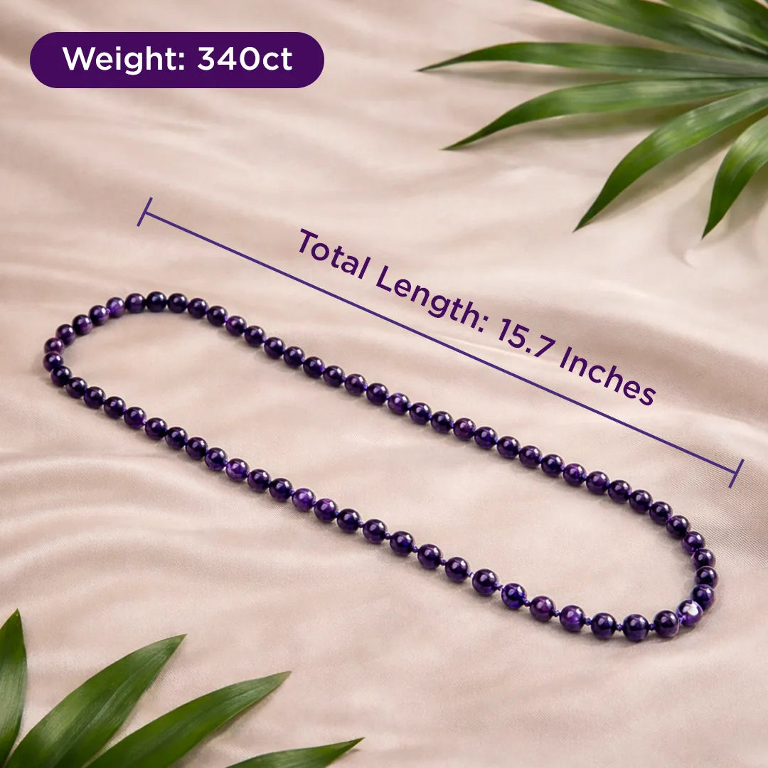 Purple beaded necklace with measurements on a beige background with green leaves.