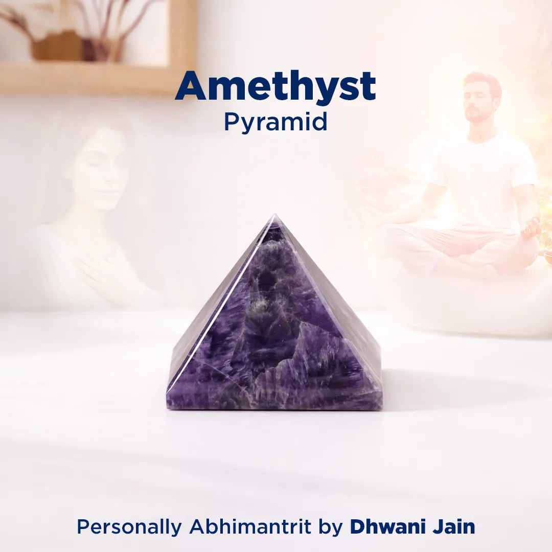 Amethyst pyramid on a white surface with a blurred background