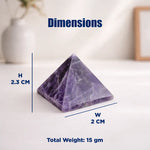Pyramid-shaped purple stone with measurements on a white surface