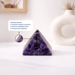 Amethyst pyramid crystal on a white surface with text about its benefits.
