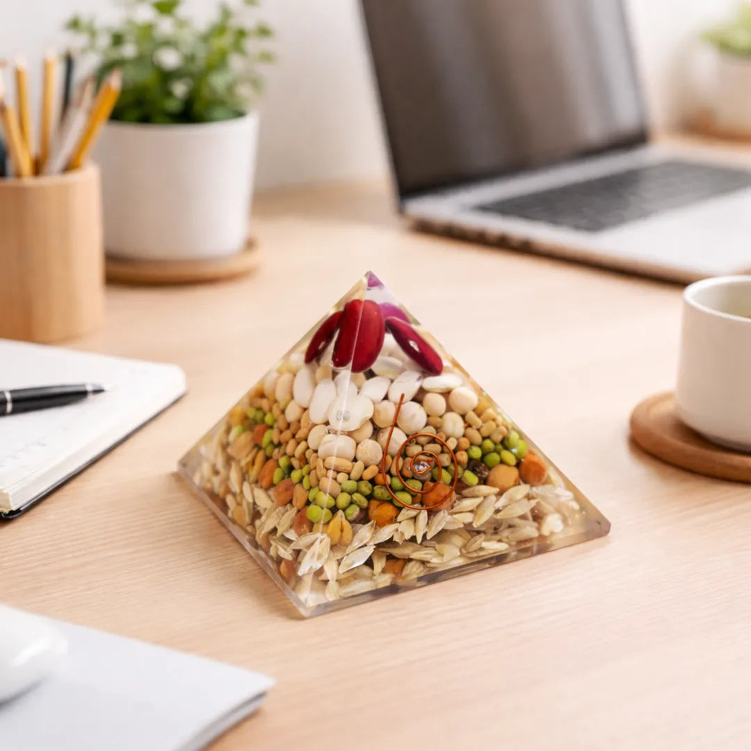 Pyramid-shaped snack mix on a desk with a laptop and office supplies.