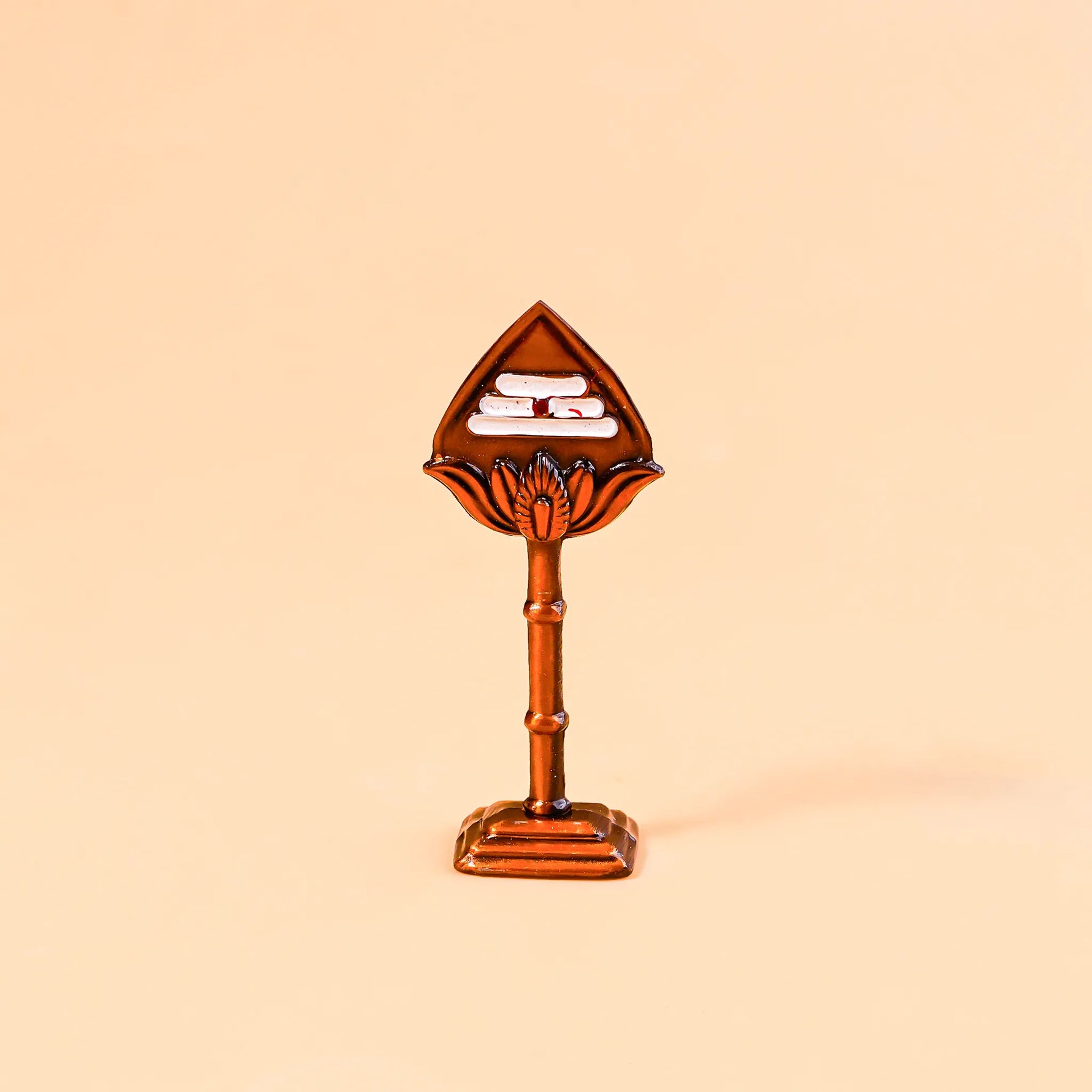 Decorative item with a leaf-shaped top and cylindrical base on a beige backgroundMurugan Vel – Divine Protection & Victory Symbol | Abhimantrit & Certified