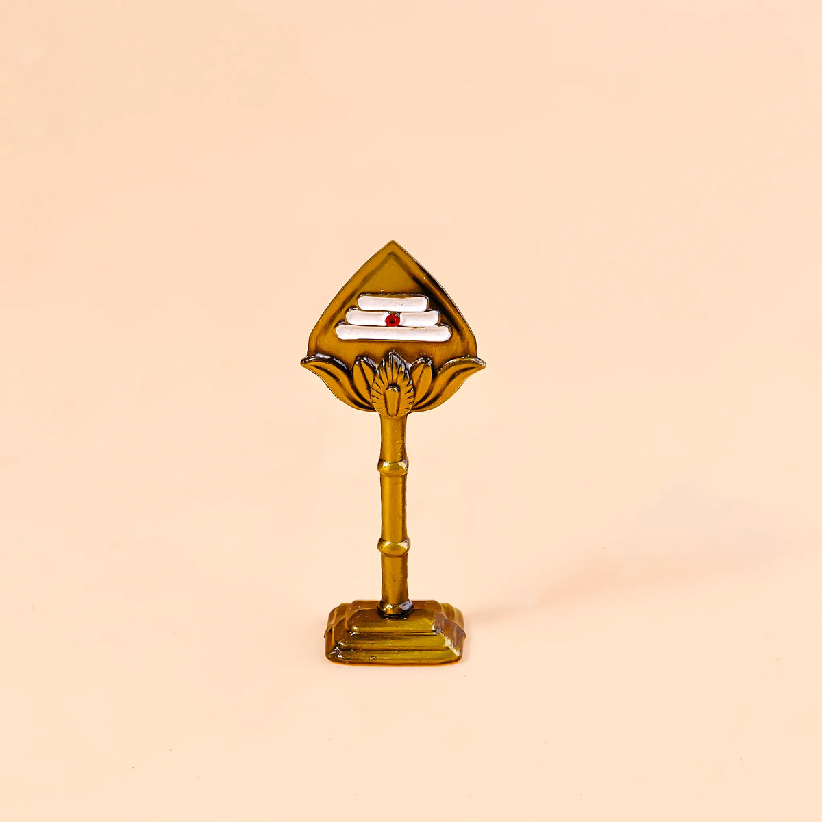 Decorative object resembling a palm tree with a book on top against a beige background