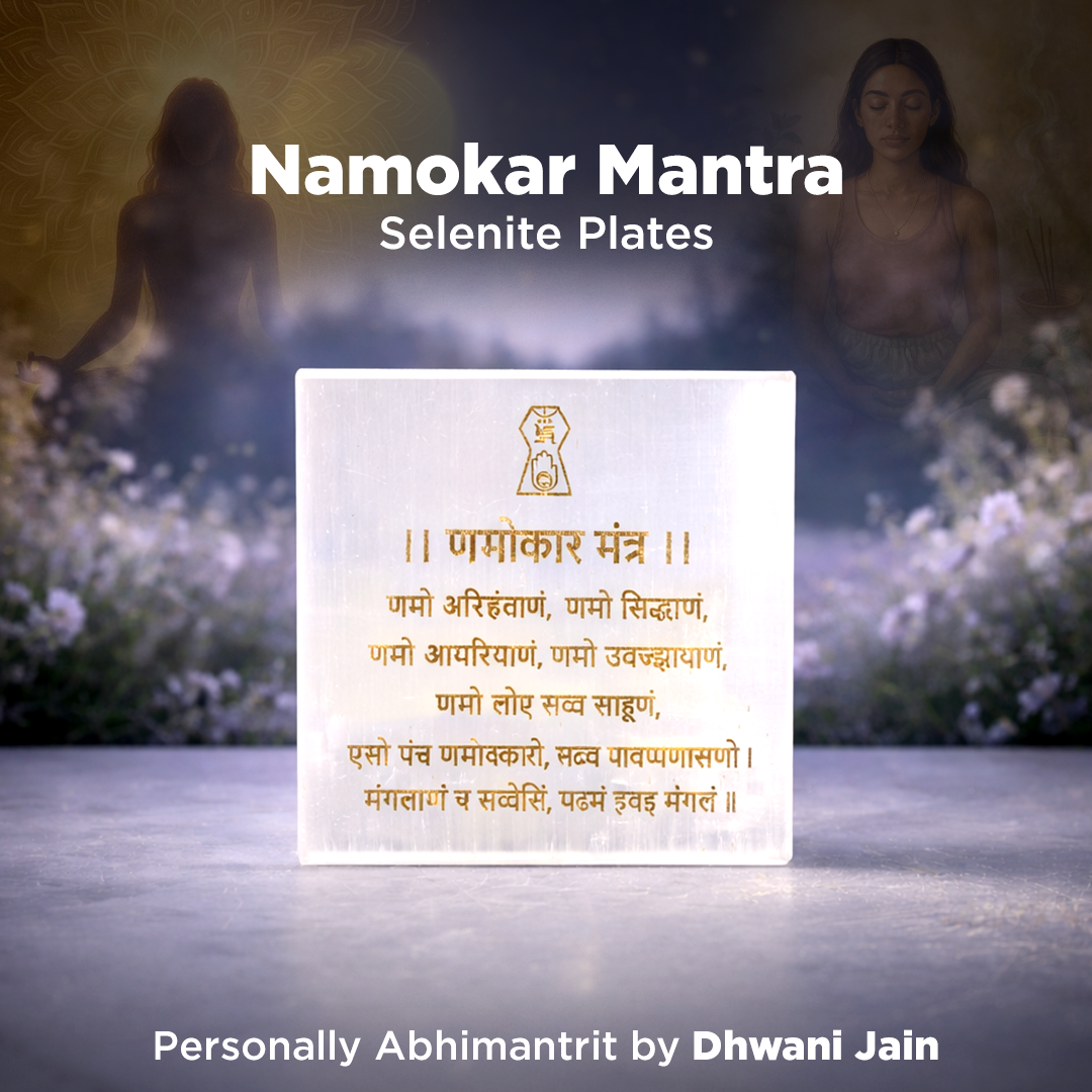 Selenite plates with Namokar Mantra text, featuring a blurred natural background.