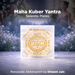 Maha Kuber Yantra Selenite Plates with a blurred background of two people and plants.