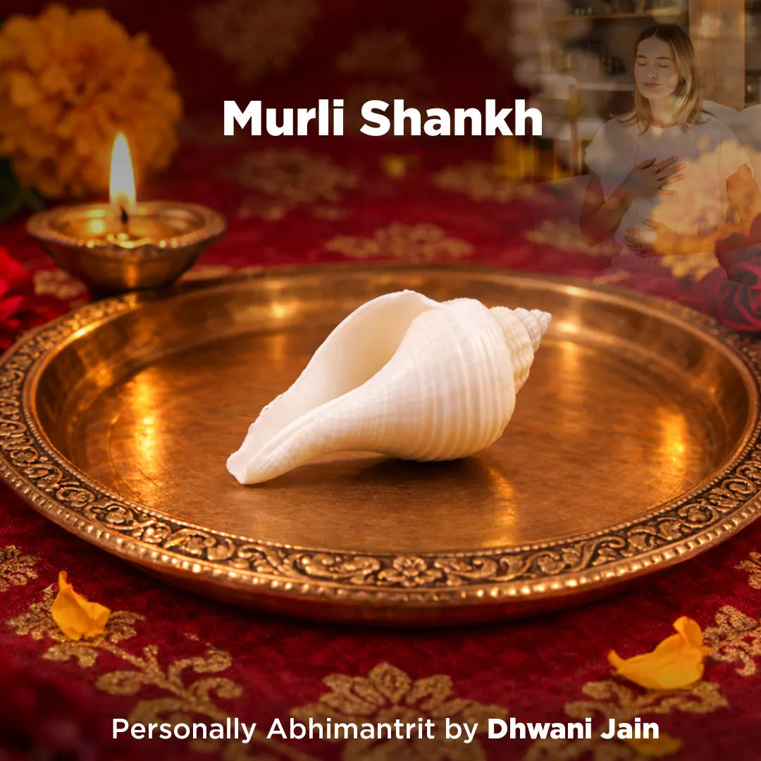 Conch shell on a decorative tray with lit lamp and flowers, featuring 'Murli Shankh' text.
