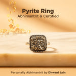 Pyrite ring with decorative design on a beige background, featuring text about certification and branding.