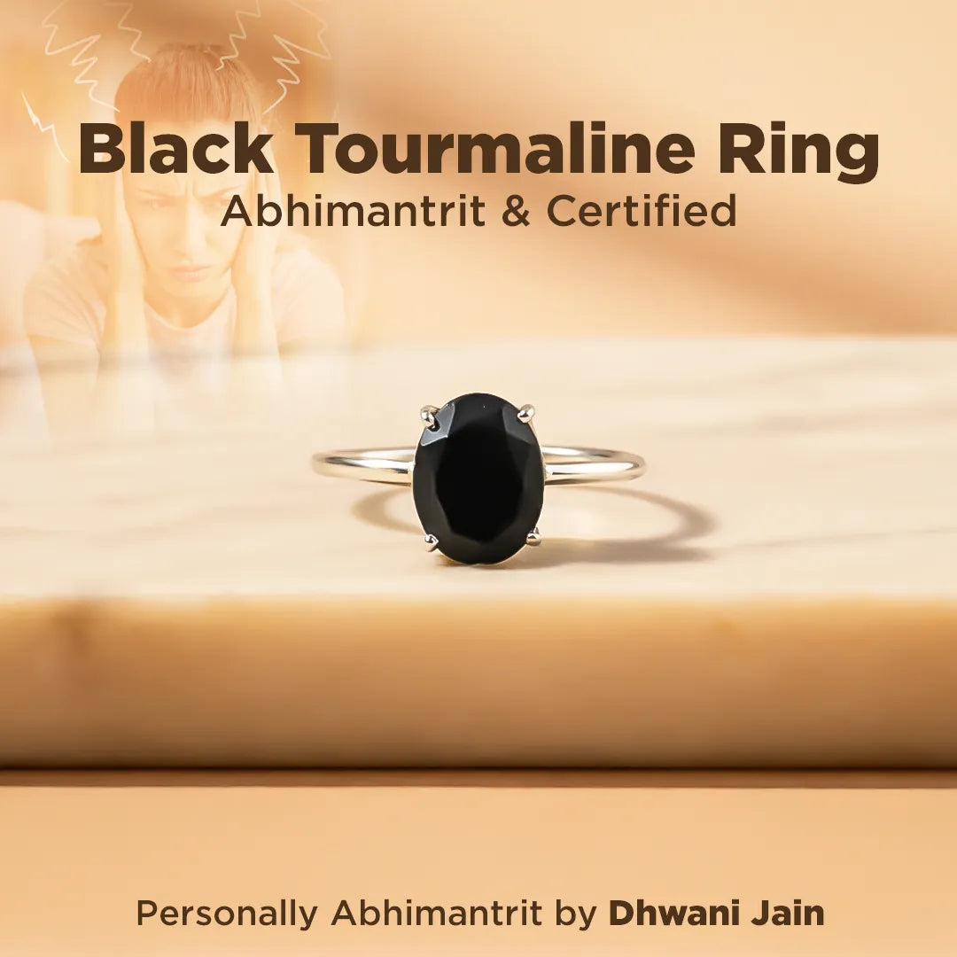 Black tourmaline ring on a wooden surface with text about certification and branding.