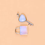 Heart-shaped key and lock pendant on a beige background