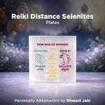 Reiki Distance Selenites plates with symbols and text on a blurred natural background