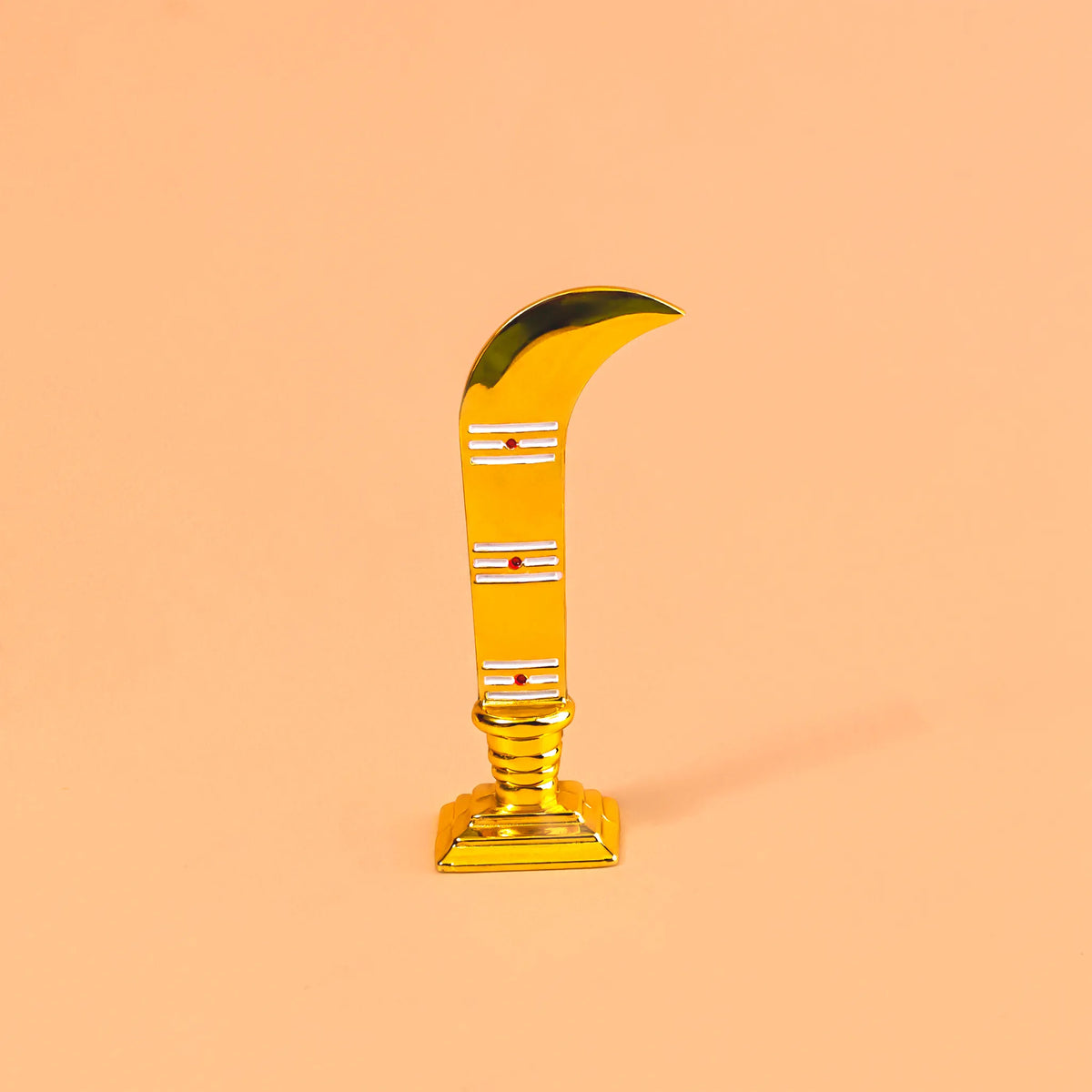 Gold curved object on a peach background