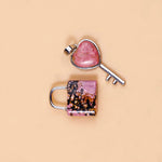 Heart-shaped key and lock charm on a beige background