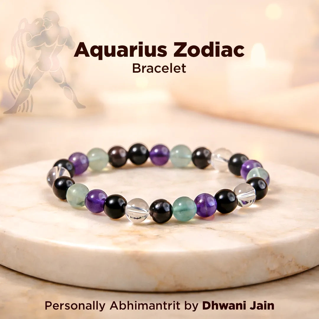 Aquarius Zodiac bracelet with colored beads on a marble surface, featuring the brand 'Dhwani Jain'.
