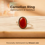 Carnelian ring on a wooden surface with text about certification and branding.